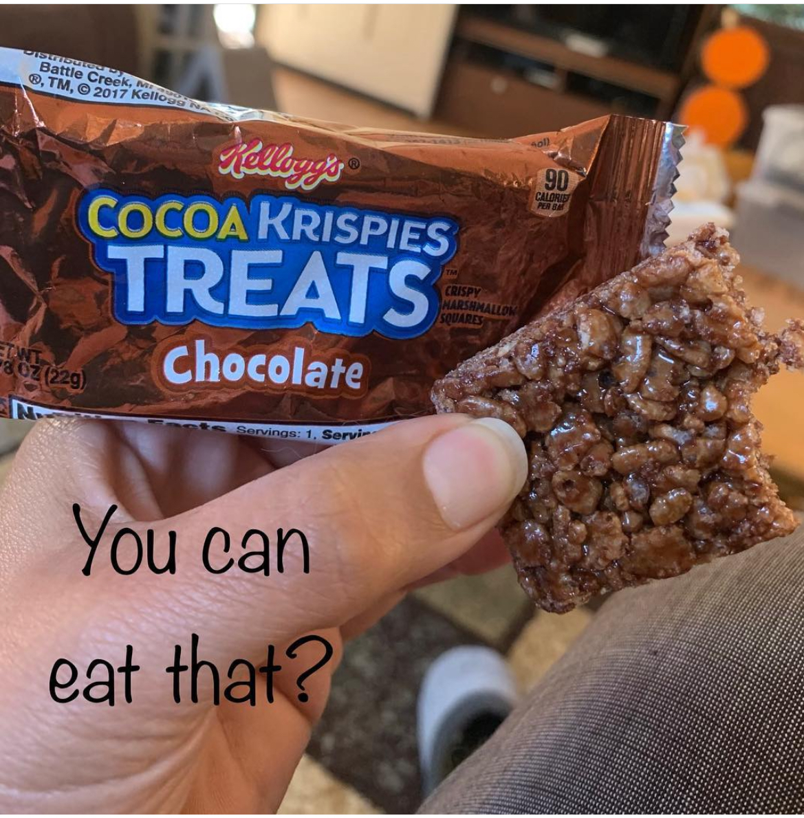 A hand holding a Cocoa Rice Krispy Treat with the text You can eat that? superimposed on over the image